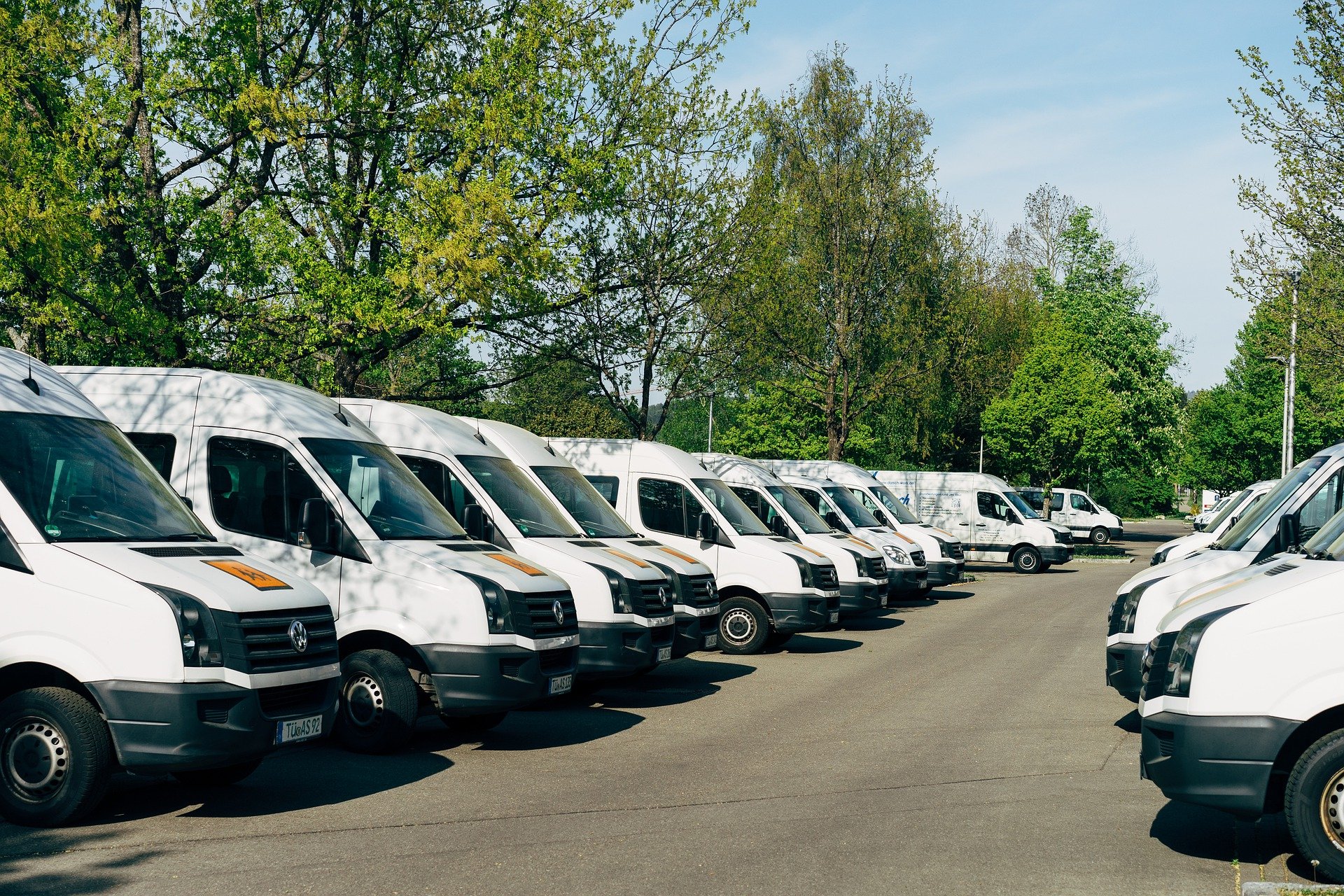 A fleet of white vans
